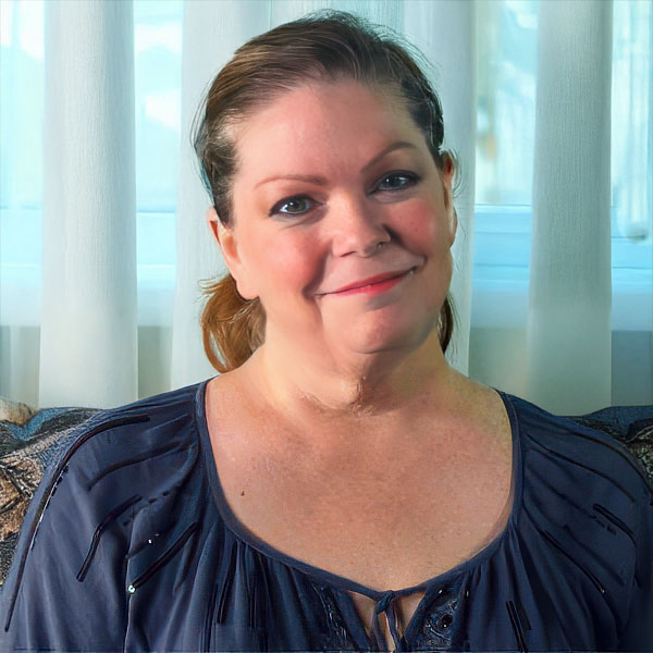 Middle-aged brunette woman with a wry smile