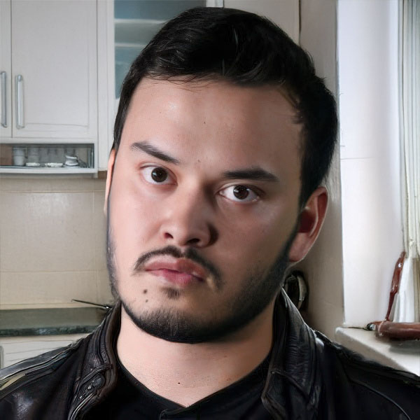 Serious-looking young man with short dark hair and facial hair