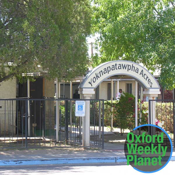 Front entrance to Yoknapatawpha Acres nursing home with the Oxford Weekly Planet logo in the foreground