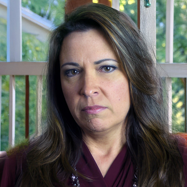 Angry-looking woman with long dark hair