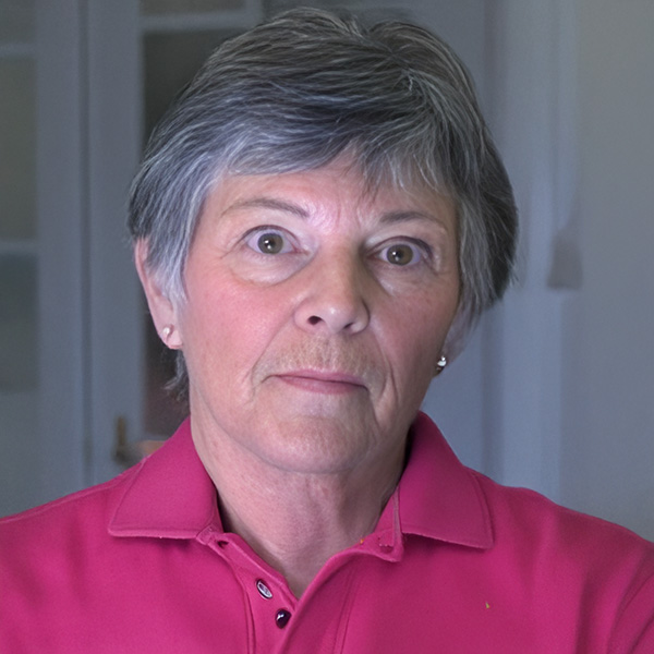 Unsmiling older woman with dark, graying hair